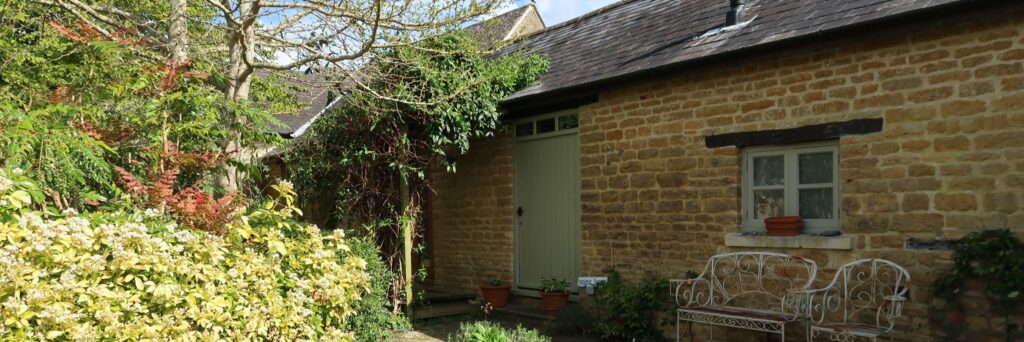 Garden approach and entrance door to treatment barn photographed by Katie Lee Photography